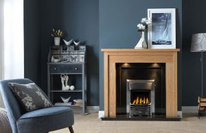 Askham Fireplace Suite in Light Oak Veneered MDF complete with Back Panel and Hearth in Ebony Granite, shown with Gallery Baltimore in Chrome Finish with Glass-Fronted Gas Convector Fire