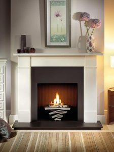 Brompton 56" Agean limestone mantel with Astra fire basket in chrome finish, decorative gas fire with ceramic driftwood, slate slips, black painted reeded fireboard chamber, 54" slate hearth and slate back hearth